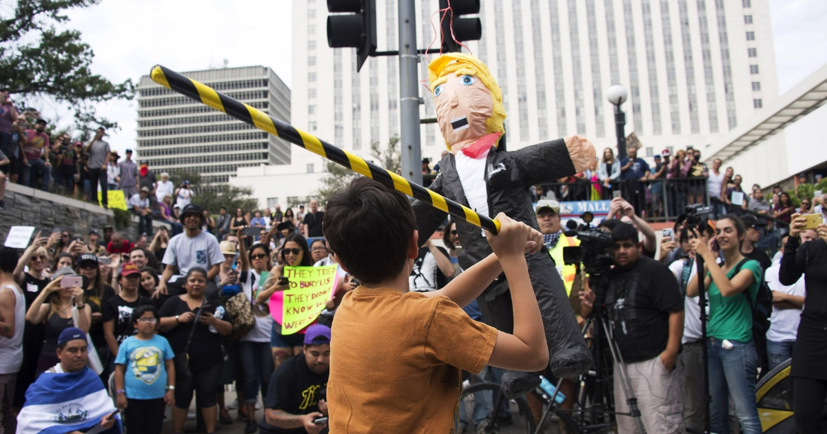 A Donald Trump pinata is hit as thousands of people protest in the streets against President-elect Donald Trump in front of Federal Building on November 12, 2016 in Los Angeles, California.