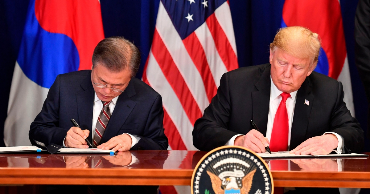 U.S. President Donald Trump and South Korean President Moon Jae-in sign a trade agreement
