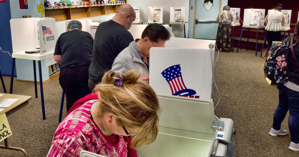 Voters mark ballots at a polling place in the library at the Robert F. Kennedy Elementary School in Los Angeles on June 5, 2018.