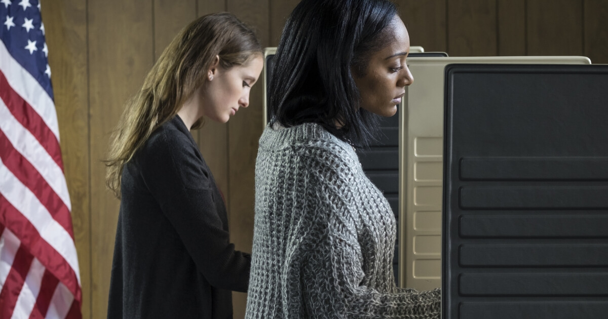 two women voting in voting booths