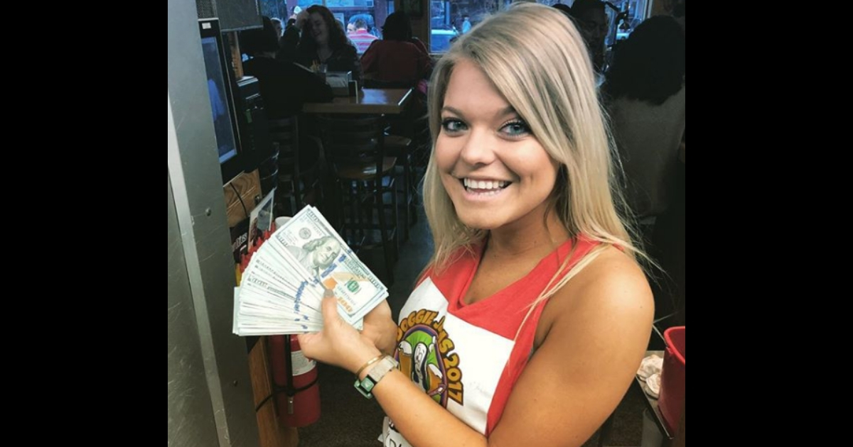 A waitress holding a wad of cash.