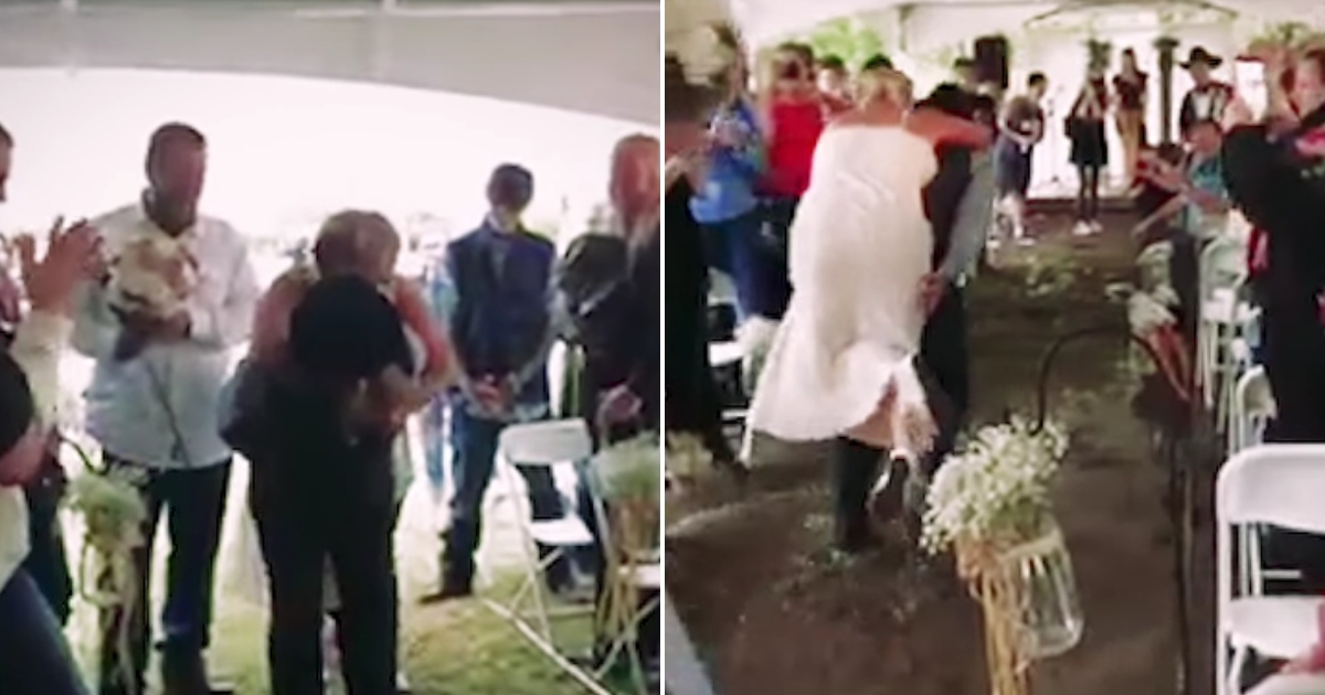 A groom carries his bride down a muddy aisle on his back.