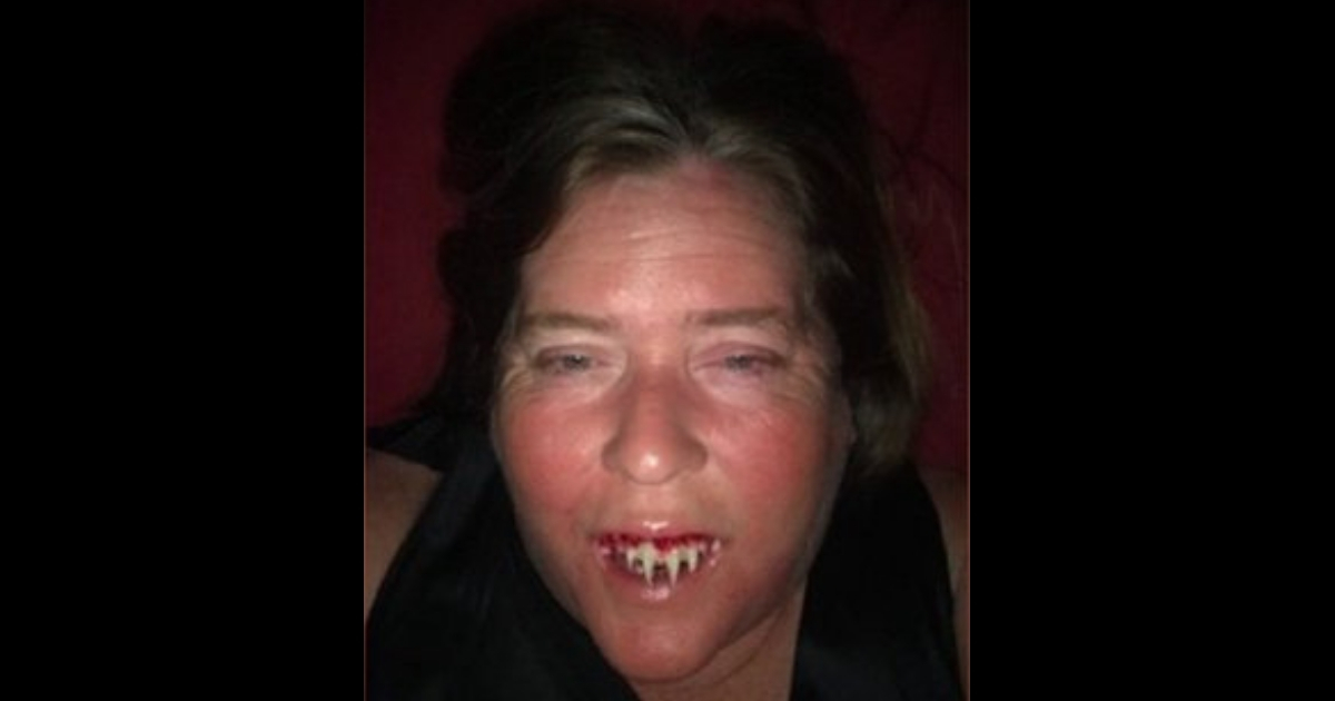 Woman with fake vampire teeth
