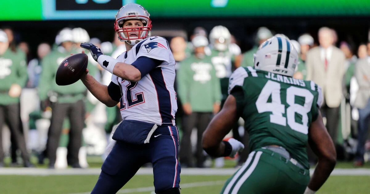 New England's Tom Brady throws a pass during the first half of his team's win over the New York Jets on Sunday.