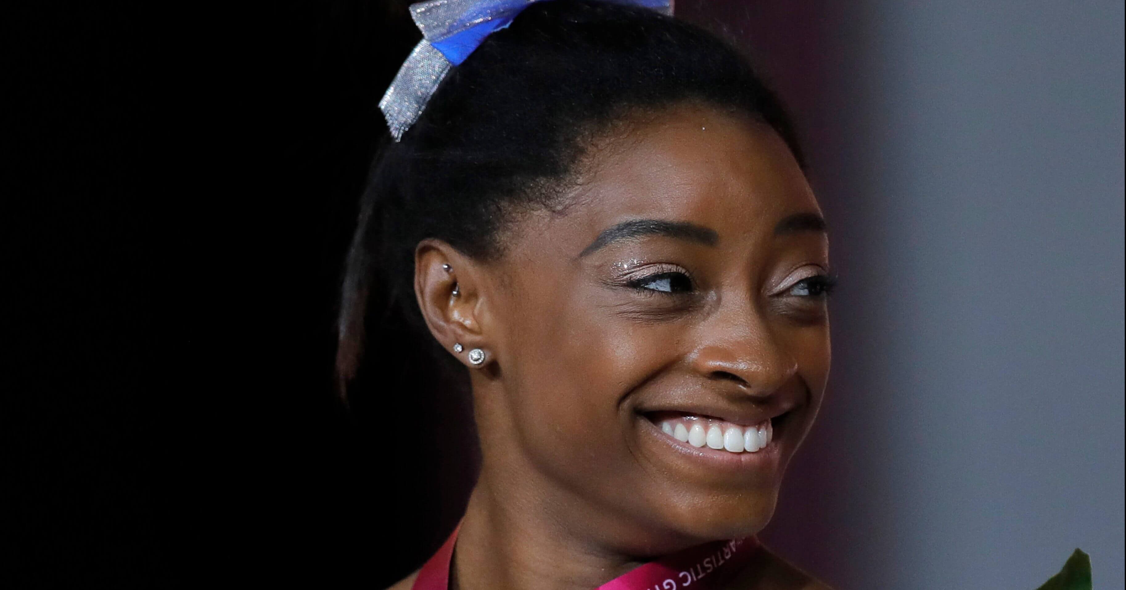 Simone Biles of the U.S. holds her silver medal after the women's uneven bars final on the first day of the apparatus finals of the Gymnastics World Championships at the Aspire Dome in Doha, Qatar, on Friday.
