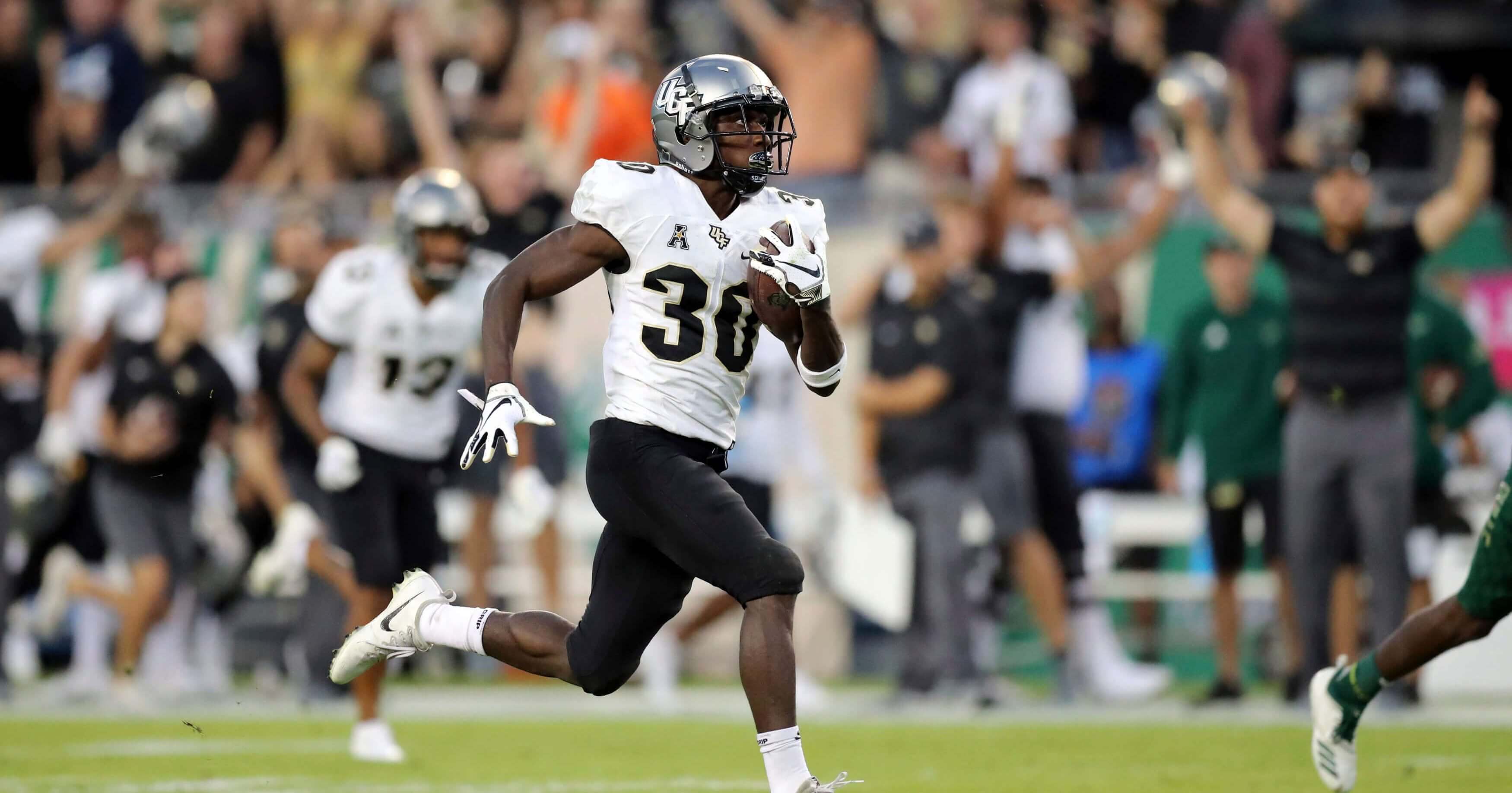 Central Florida's Greg McCrae breaks away to score a touchdown against South Florida during the first half Friday in Tampa.