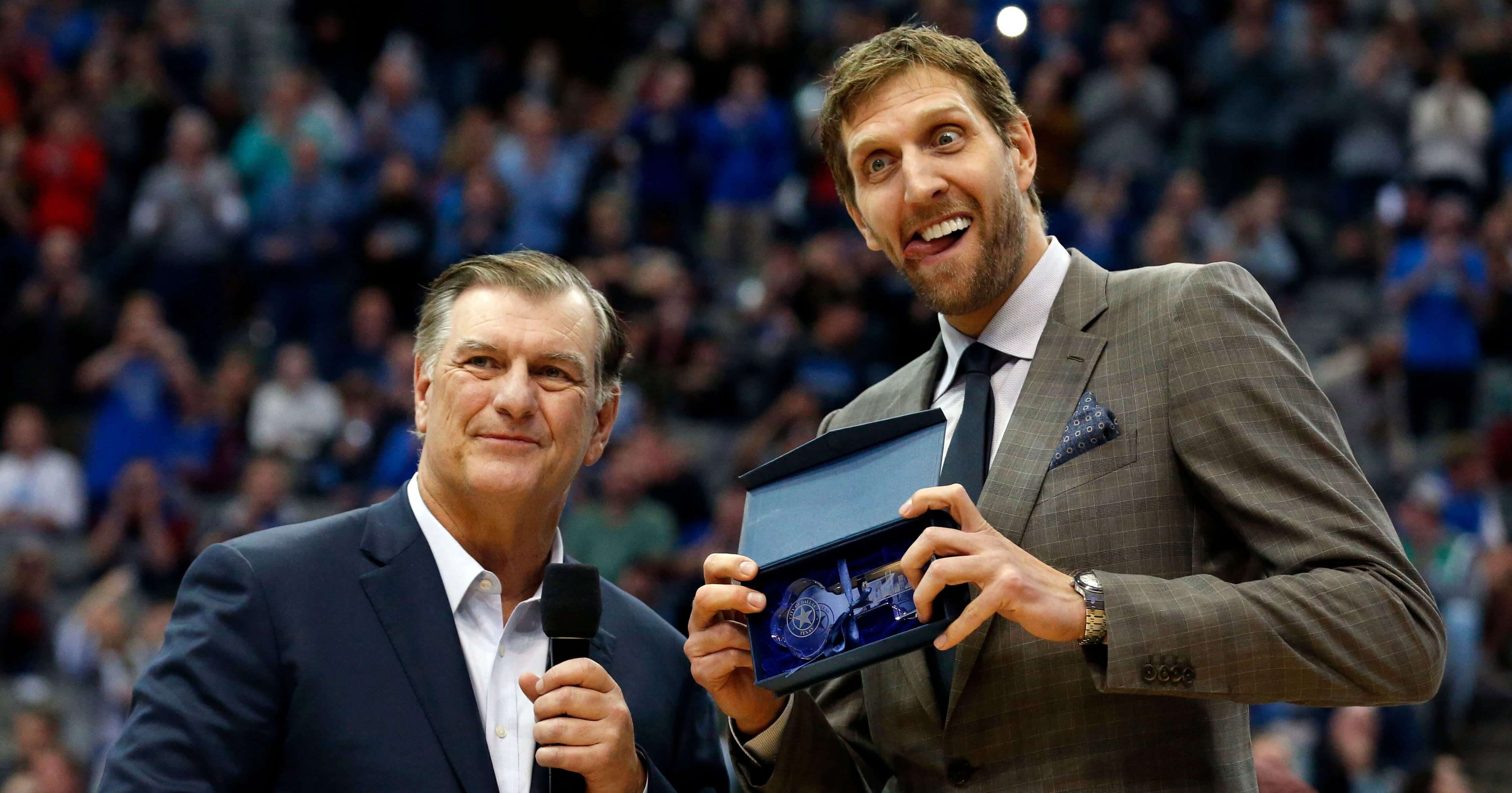 Dallas Mavericks player Dirk Nowitzki makes a face as he is presented with the key to the city of Dallas by Mayor Mike Rawlings, left, during halftime of the Mavs' game against the Brooklyn Nets on Wednesday.