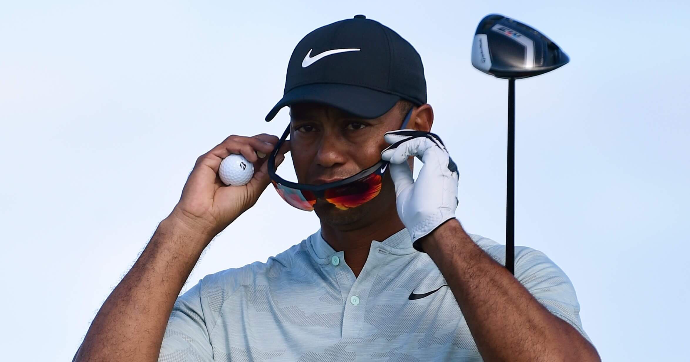 Tiger Woods adjusts his sunglasses before hitting from the seventh hole during the first round of the Hero World Challenge at the Albany Golf Club in Nassau, Bahamas on Thursday.