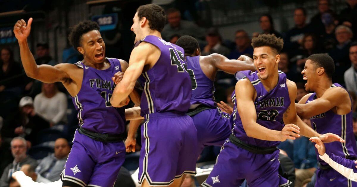 Furman players celebrate after their team defeated Villanova 76-68 in overtime Saturday.