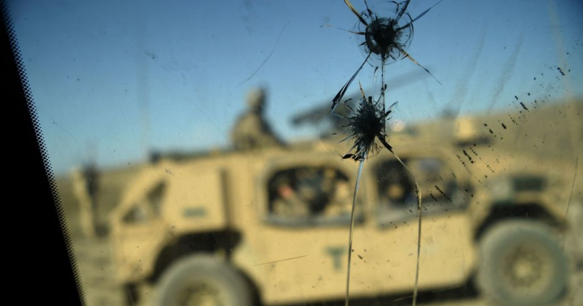 U.S. Army soldiers from NATO are seen through a cracked window of an armed vehicle in a checkpoint during a patrol against Islamic State militants in Afghanistan.