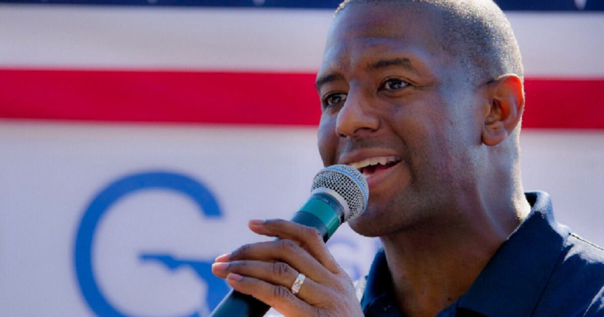 Andrew Gillum speaks into a microphone.