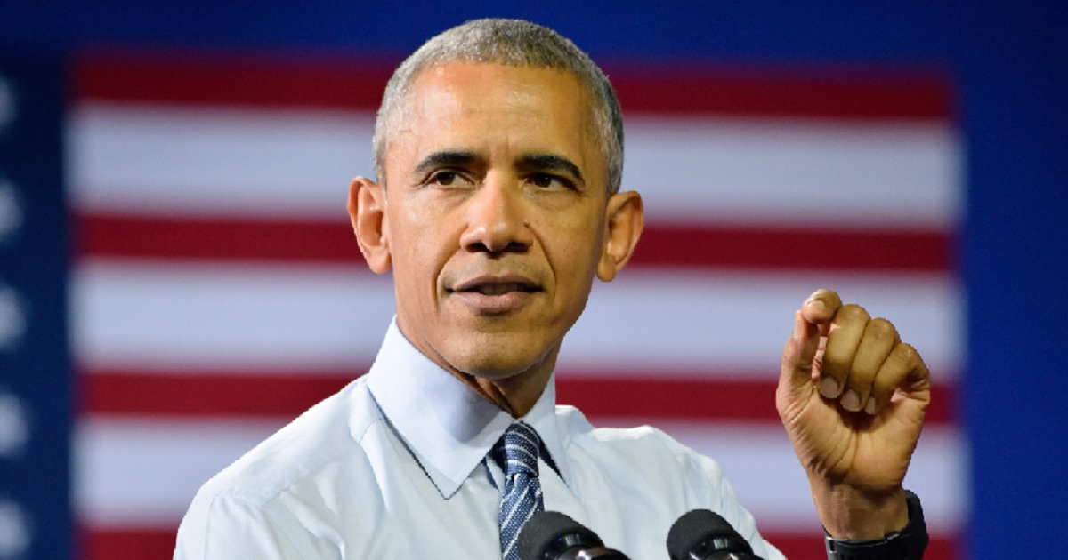 Former President Barack Obama with an American flag backdrop.
