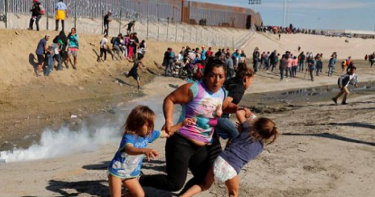 Woman with two children fleeing tear gas.