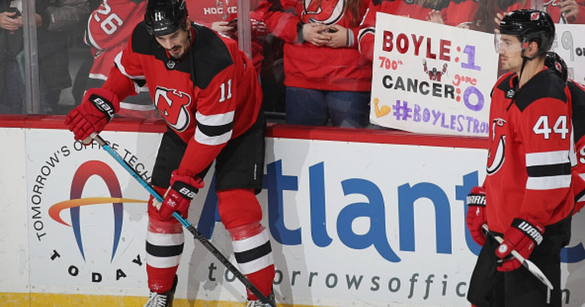New Jersey's Brian Boyle, left, warms up Oct. 25 before his 700th career game while fans salute his battle with cancer.