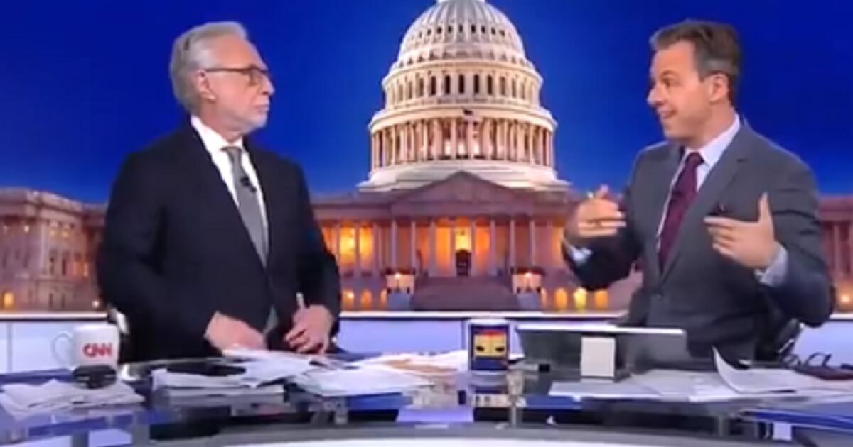 CNN's Wolf Blitzer, left, and Jake Tapper commiserate Tuesday as it becomes clear that the "blue wave" of voters Democrats and pundits were banking on had failed to materialize on Election Day.