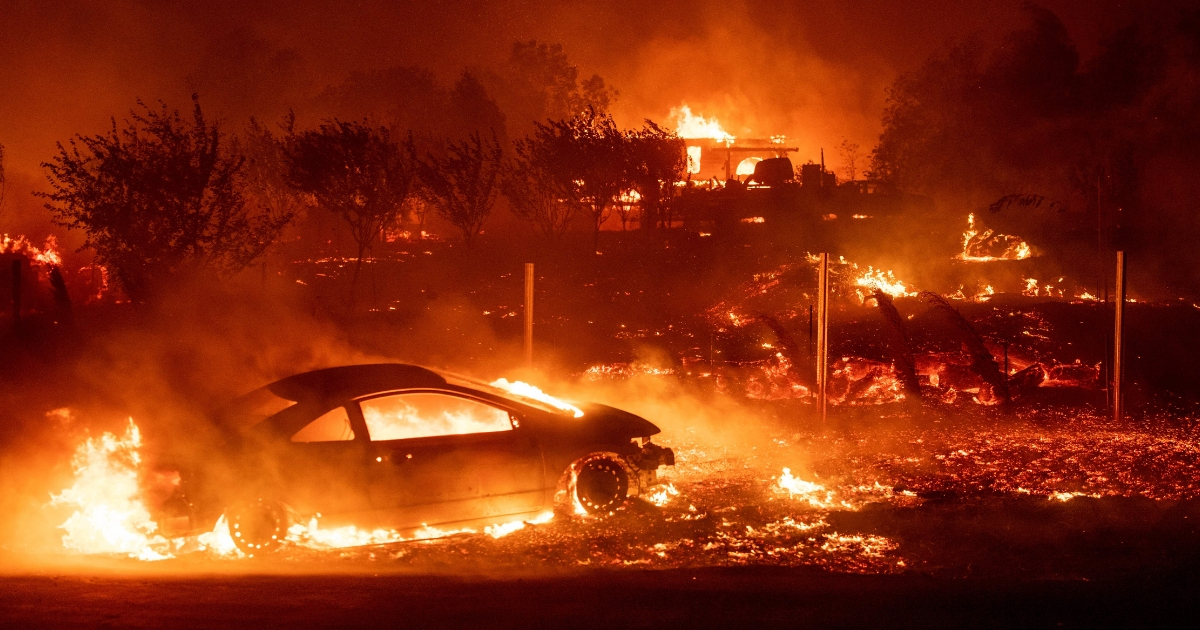 Vehicles and homes burn as the Camp fire tears through Paradise, California, on Nov. 8.