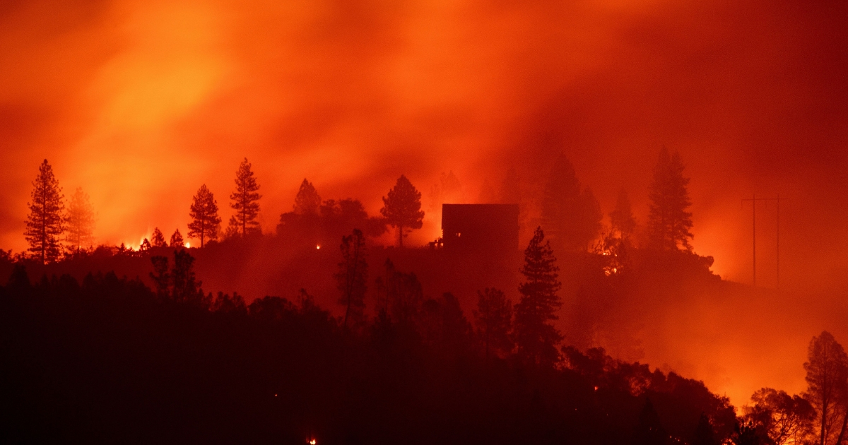 Flames from the Camp fire burn near a home atop a ridge near Big Bend, California, on Nov. 10, 2018.