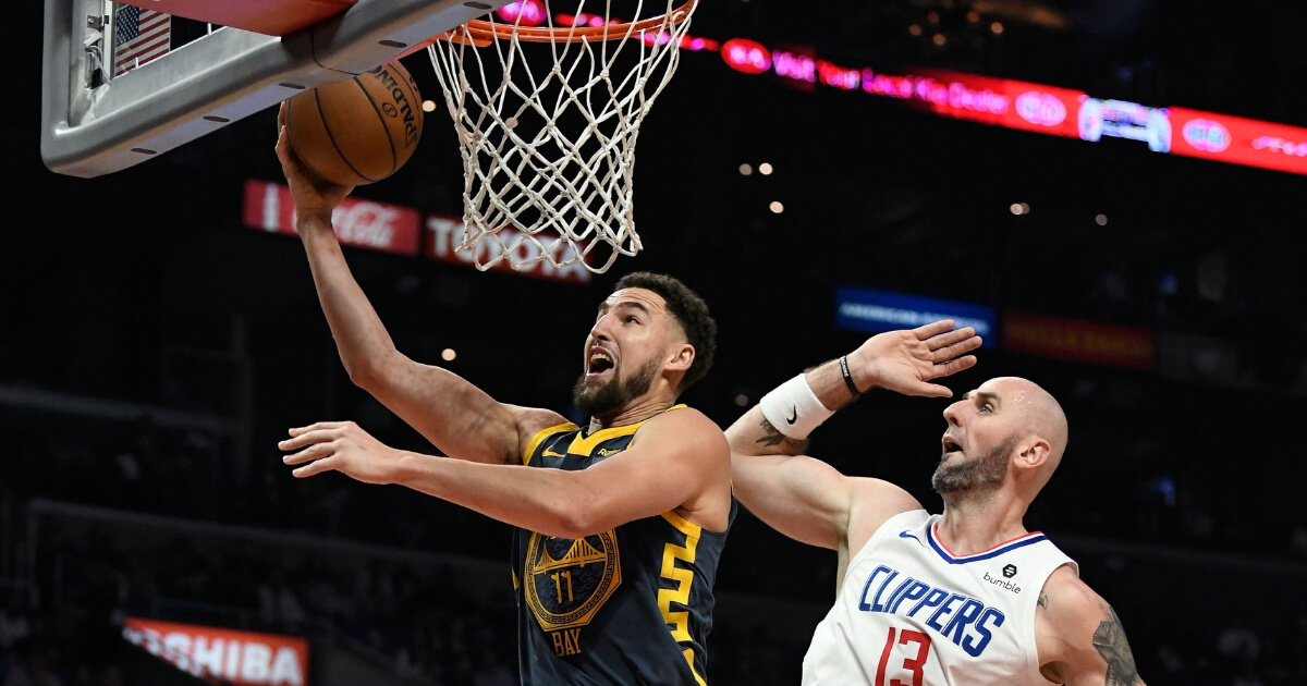 Klay Thompson of the Golden State Warriors attempts a layup against Marcin Gortat of the Los Angeles Clippers on Nov. 12 at Staples Center.