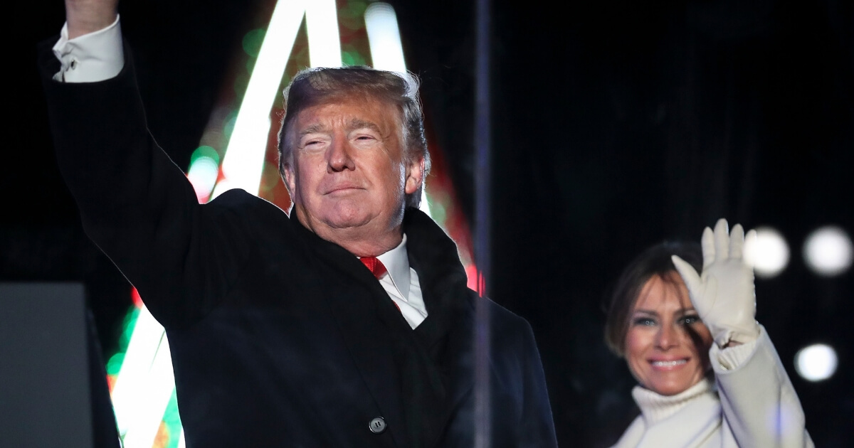 President Donald Trump and first lady Melania Trump wave during the National Christmas Tree lighting ceremony held by the National Park Service at the Ellipse near the White House on Wednesday.