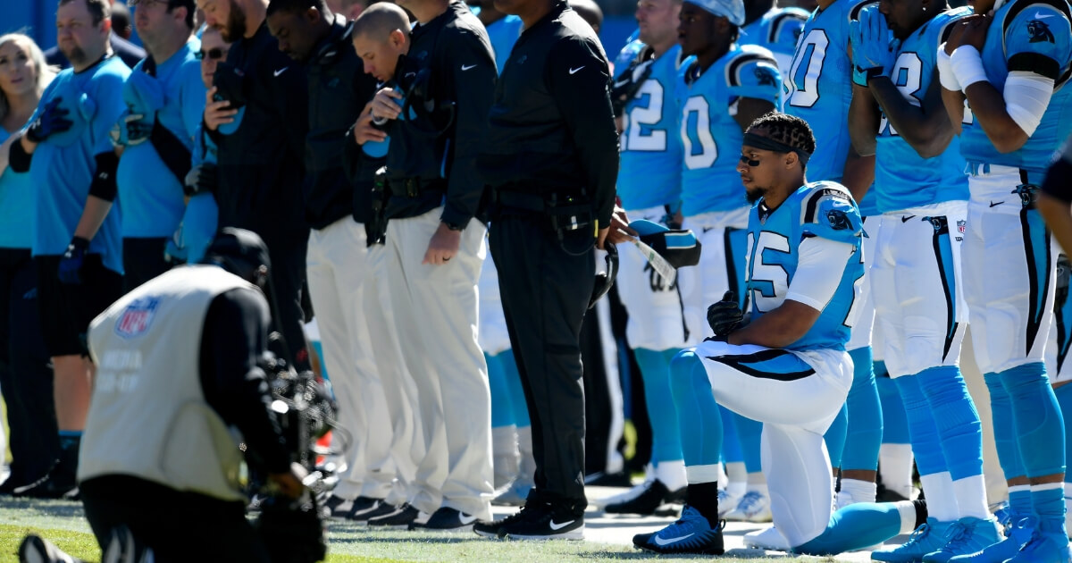 Eric Reid of the Carolina Panthers kneels in protest during the national anthem before a game against the Baltimore Ravens on Sunday.