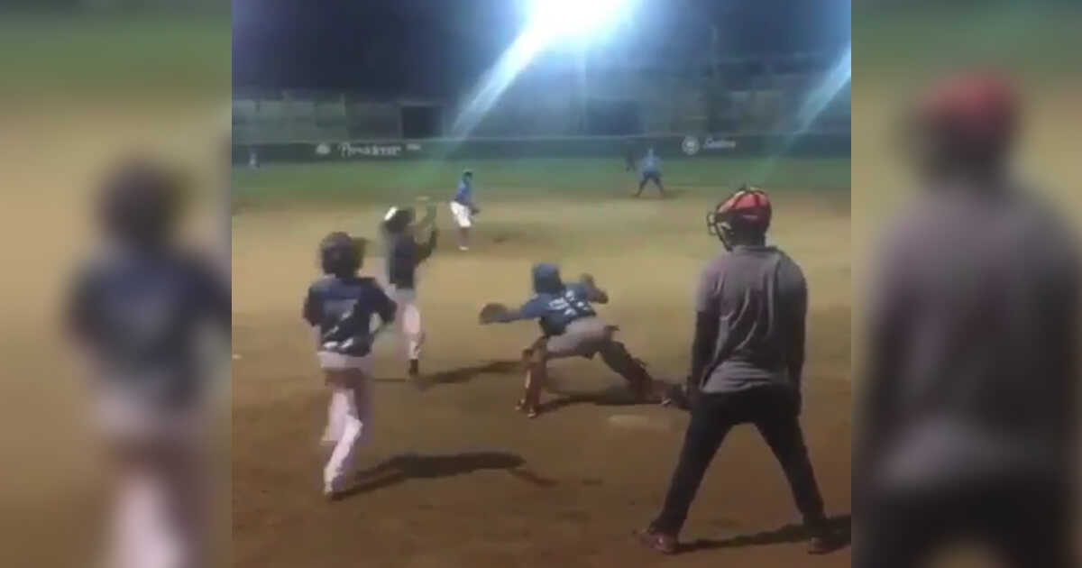 A young baseball player in the Dominican Republic went airborne over the catcher to score a run.