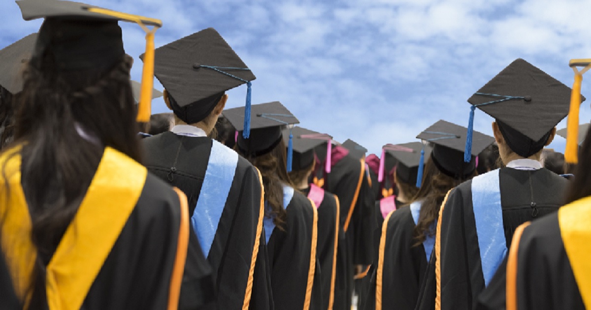 Picture of graduates in caps and gowns, from the back.