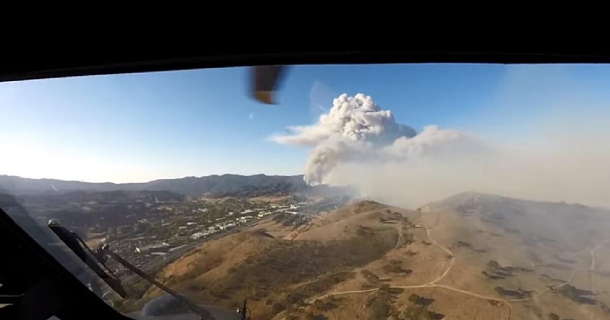 View of mountain with huge column of smoke