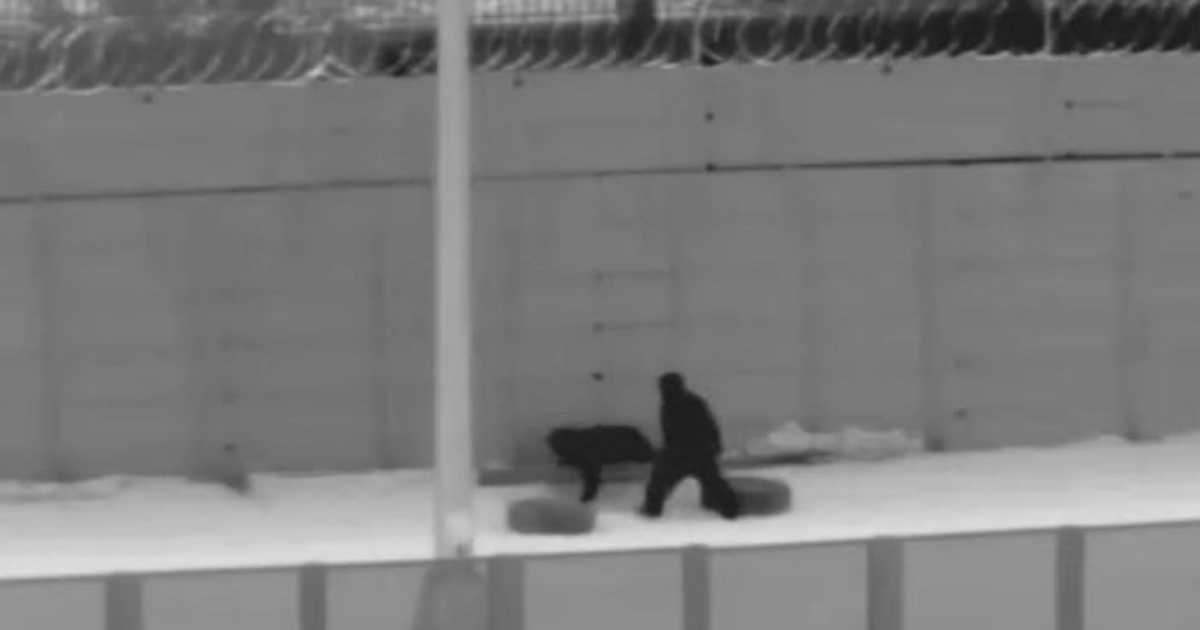 A Border Patrol camera captures Illegal immigrants crawling under the fencing east of the San Luis Port of Entry near Yuma, Arizona.