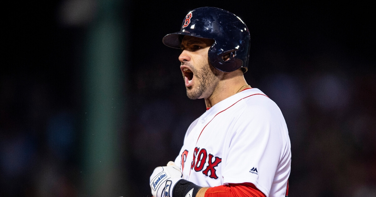 J.D. Martinez of the Boston Red Sox reacts after hitting an RBI single in Game 2 of the 2018 World Series against the Los Angeles Dodgers at Fenway Park.