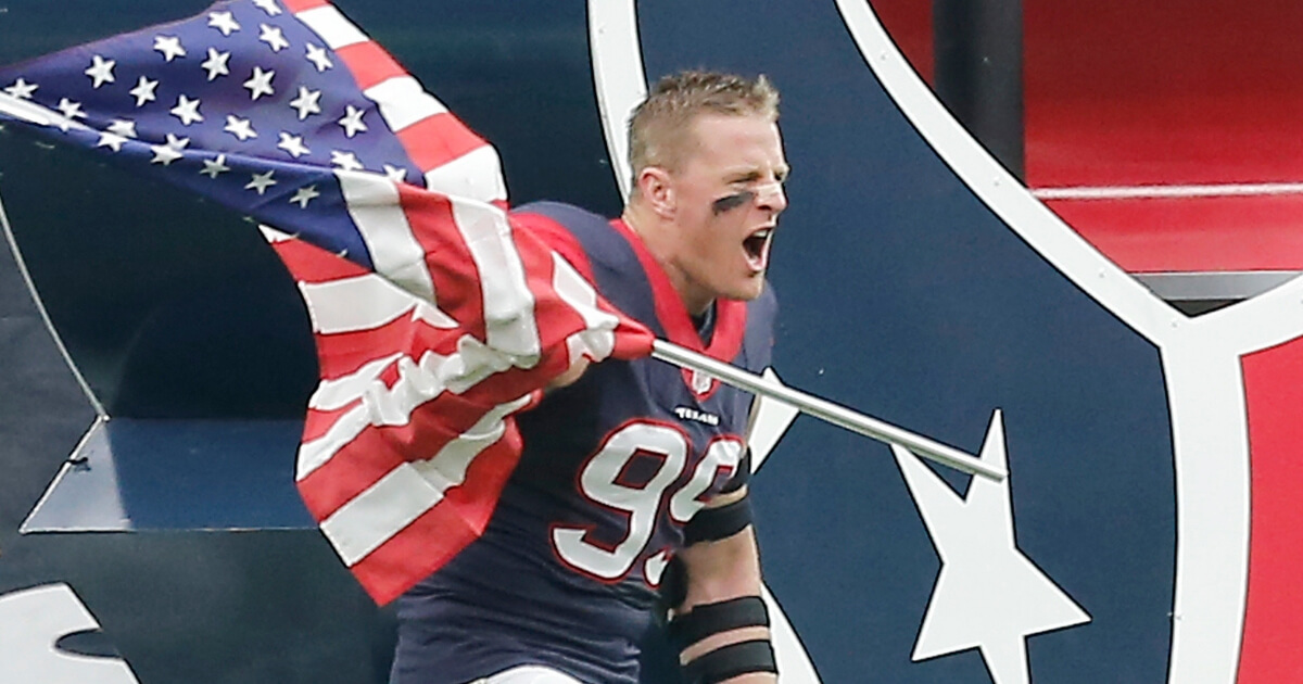 J.J. Watt of the Houston Texans runs out with the American flag before a 2015 game against the New York Jets.