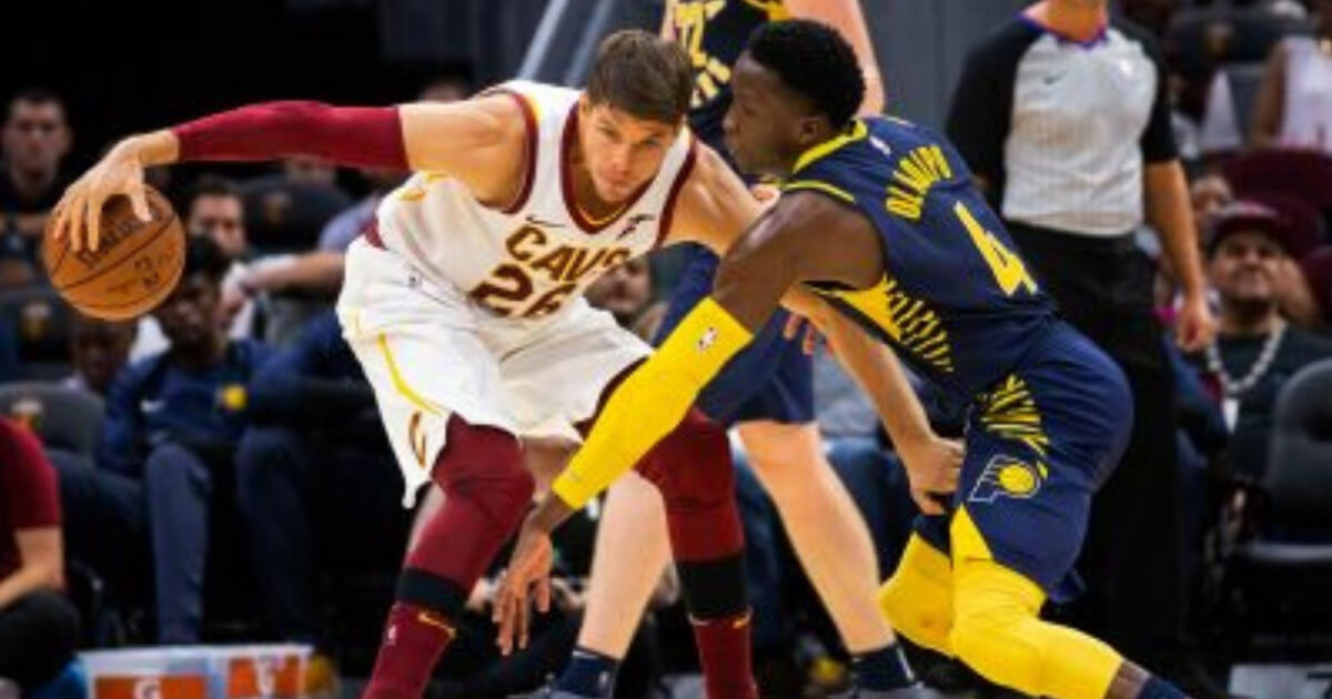 Kyle Korver with the Cleveland Cavaliers protects the ball from a defender