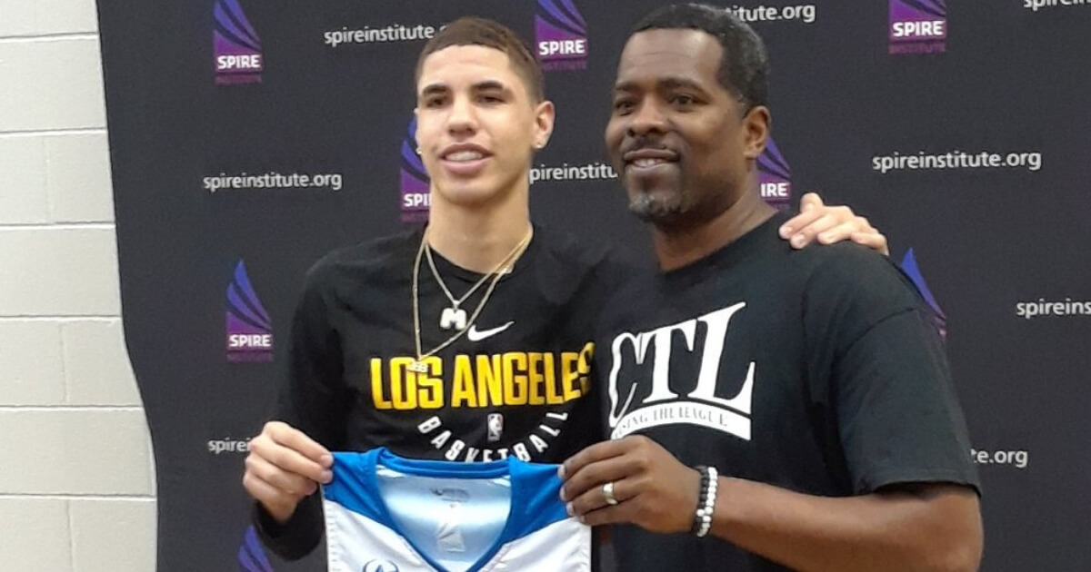 LaMelo Ball, left, poses with SPIRE Institute basketball coach Jermaine Jackson following Ball's introductory press conference.
