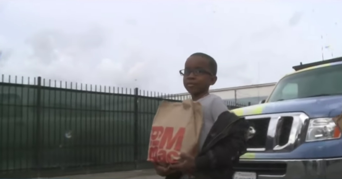 Little boy with a McDonald's bag.