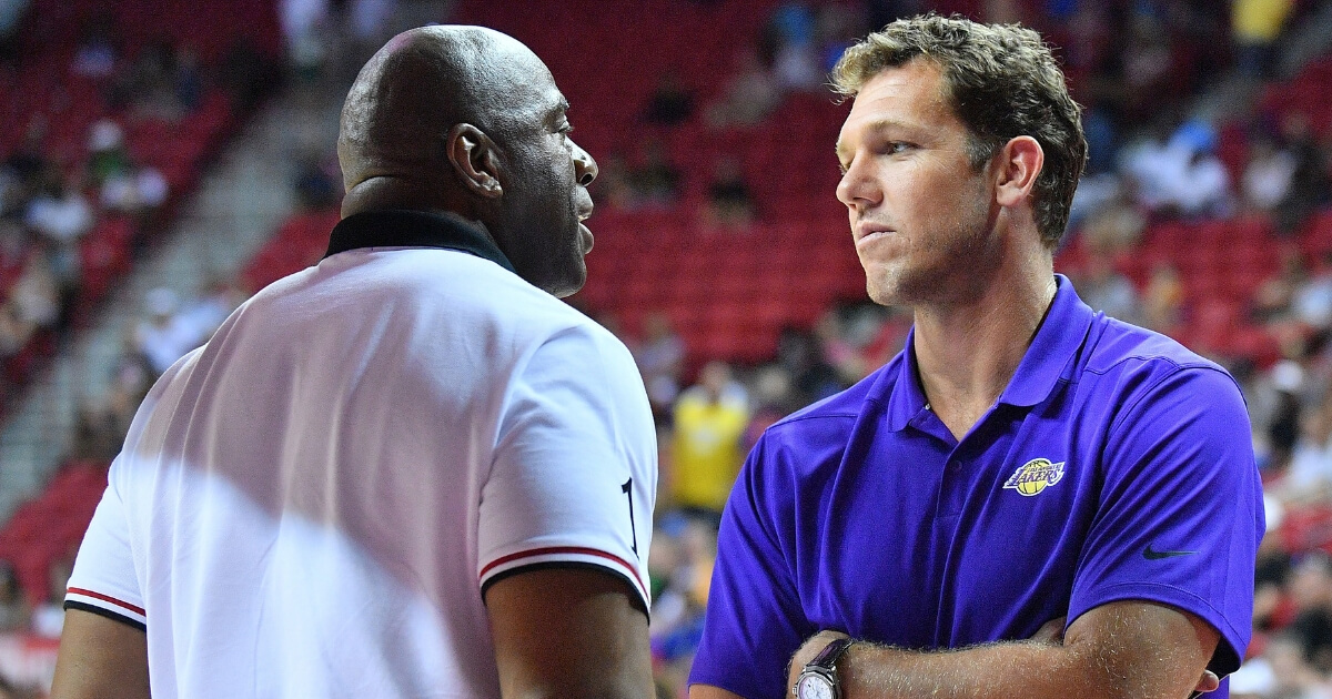 Earvin "Magic" Johnson, Lakers president of basketball operations, talks to coach Luke Walton during the NBA Summer League in Las Vegas.