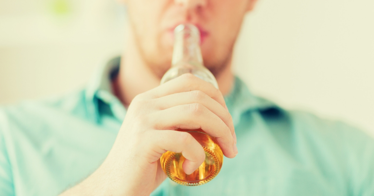 A man drinking beer.