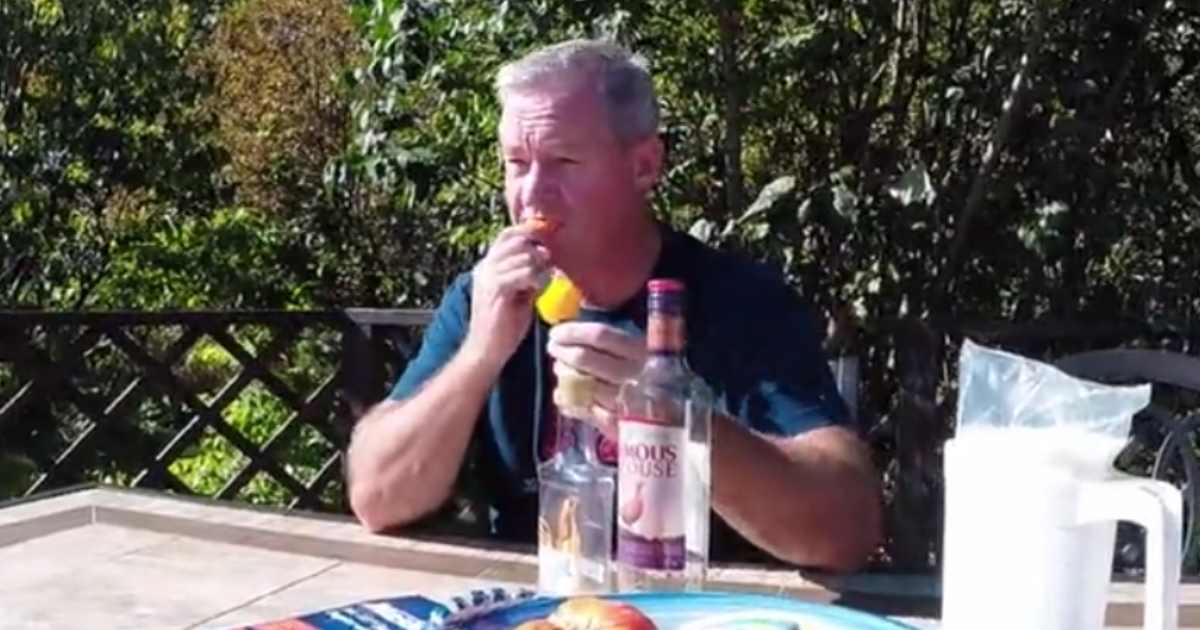 Man putting peppers in his mouth.