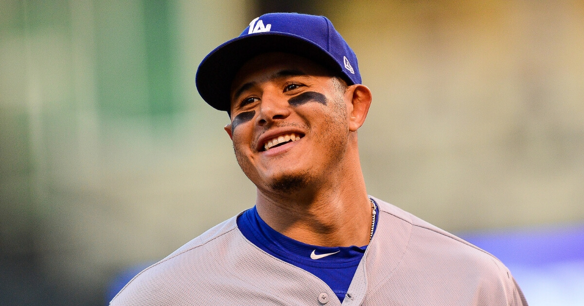 Manny Machado of the Los Angeles Dodgers smiles as he runs off the field during a Sept. 8 game against the Colorado Rockies at Coors Field.