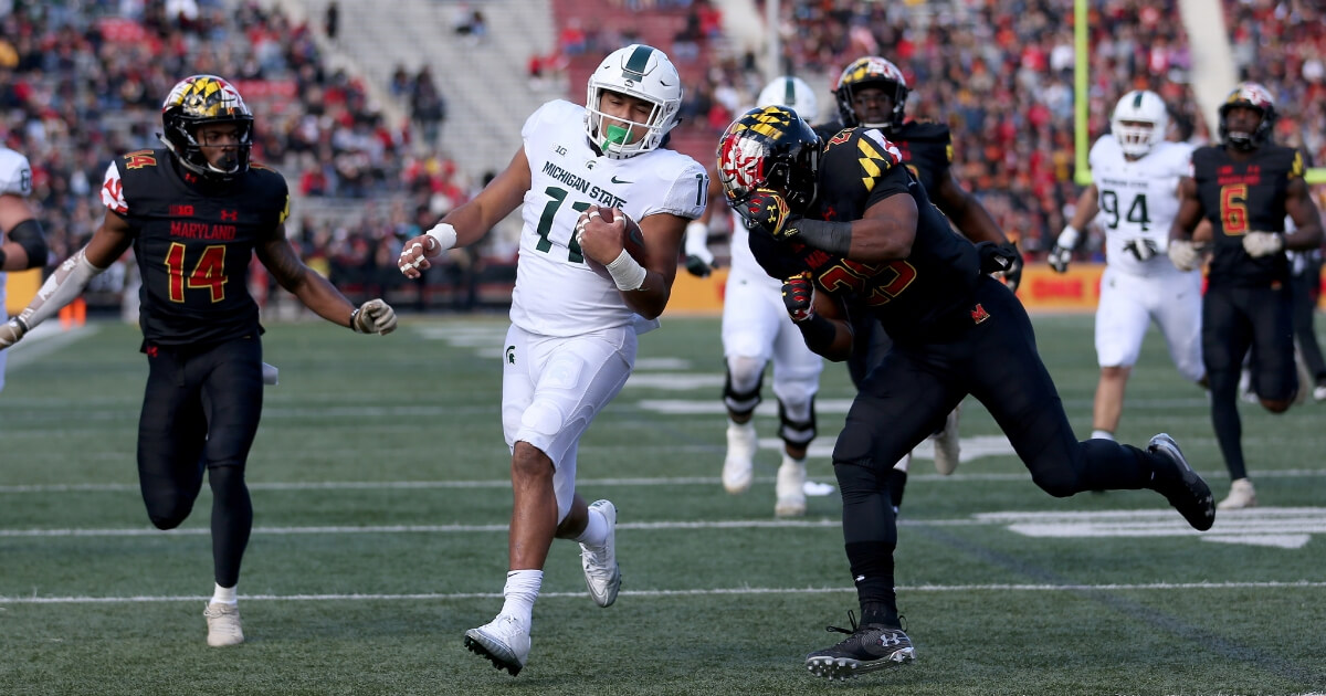 Connor Heyward of the Michigan State Spartans scores a touchdown past Deon Jones, left, and Antoine Brooks Jr. of the Maryland Terrapins on Saturday in College Park.