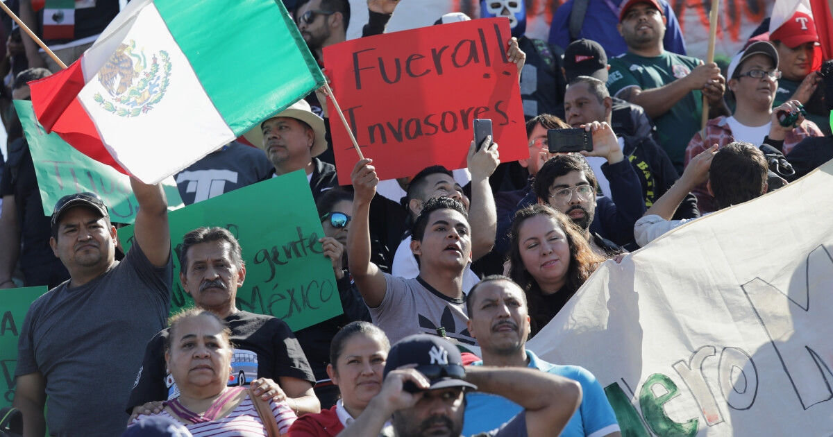 Mexican protesters demonstrate Sunday against the caravan of Central American migrants, some of whom arrived in Tijuana.