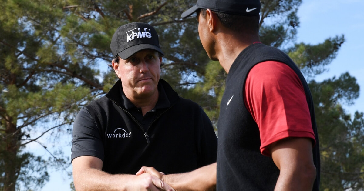 Phil Mickelson shakes Tiger Woods' hand during The Match on Friday.
