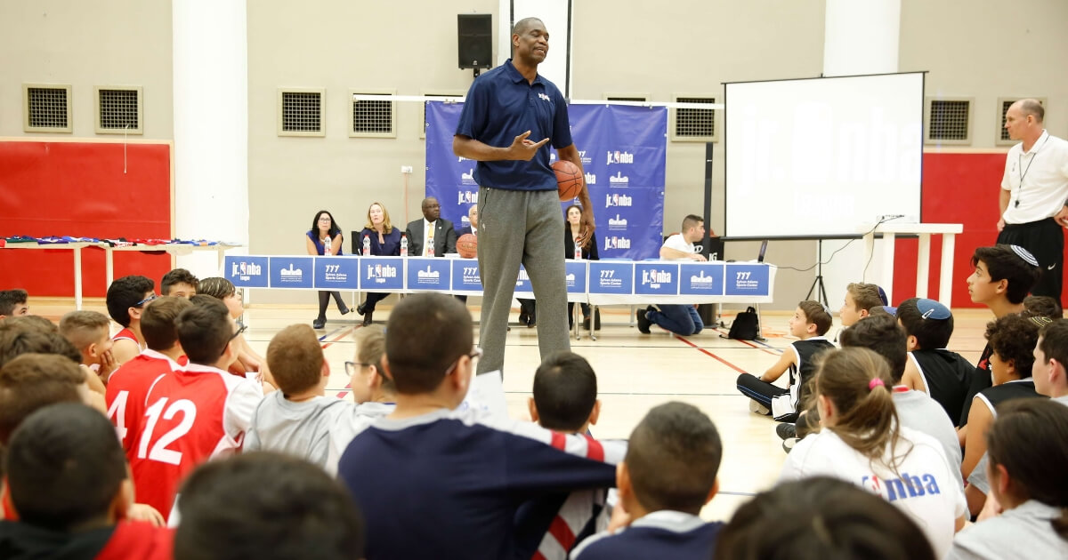 NBA Hall of Famer Dikembe Mutombo talks to kids during a workshop at the Sylvan Adams sports center at the YMCA In Jerusalem on Tuesday.