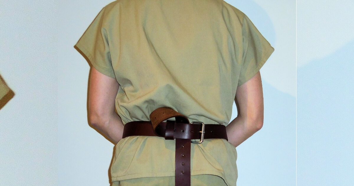 Back of a prisoner with a restraint belt.