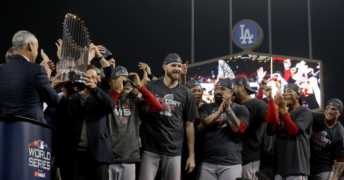 The Boston Red Sox celebrate with the World Series trophy after their 5-1 win over the Los Angeles Dodgers in Game 5 at Dodger Stadium on Sunday.