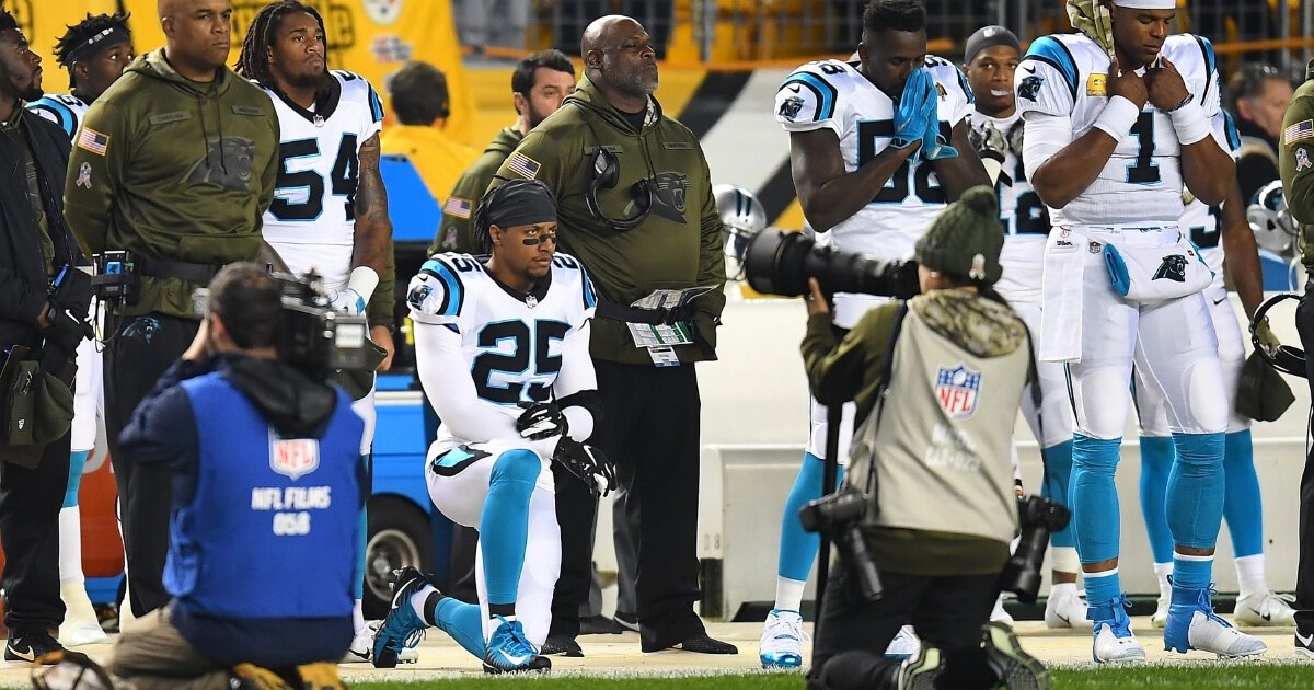 Eric Reid of the Carolina Panthers kneels in protest during the national anthem before Thursday night's game against the Pittsburgh Steelers at Heinz Field.