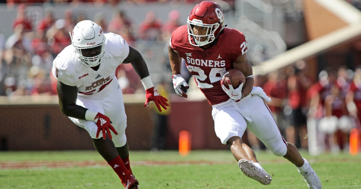 Running back Rodney Anderson of the Oklahoma Sooners cuts in front of a Florida Atlantic defender during a Sept. 1 game in Norman.
