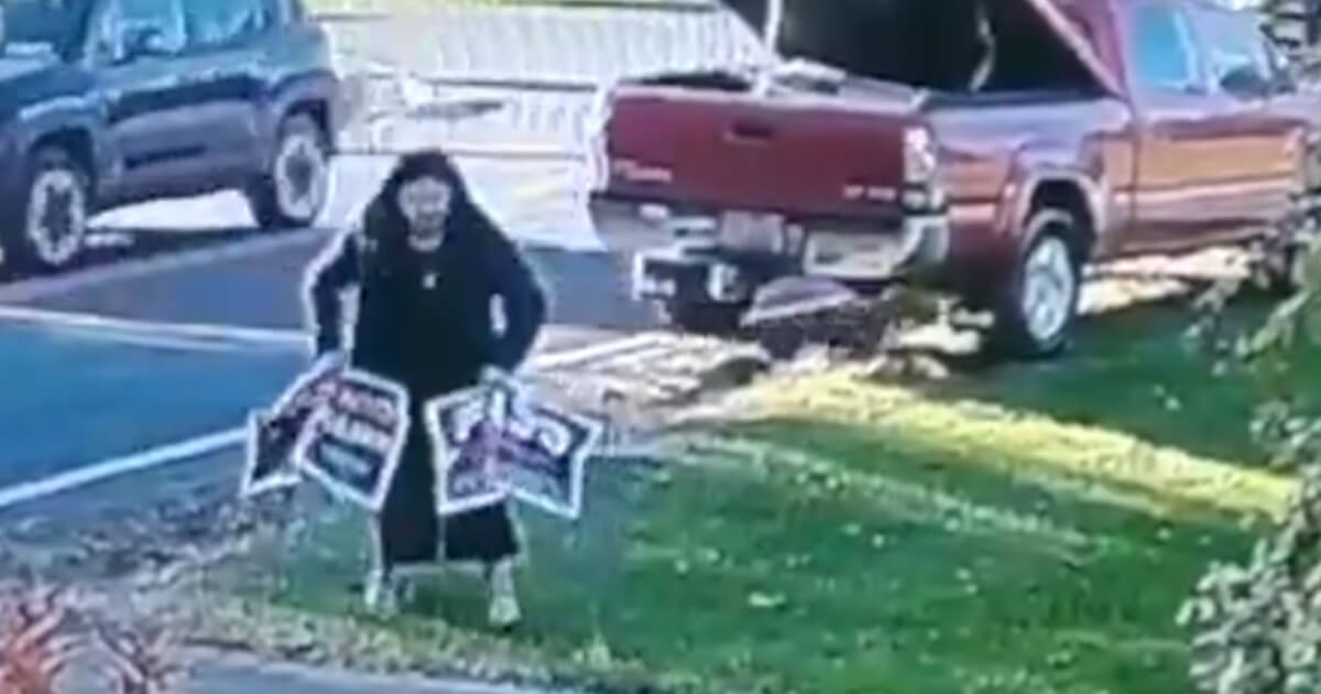 A home security camera captured video of a university employee taking signs for two Republican candidates from the yard of a New York resident.