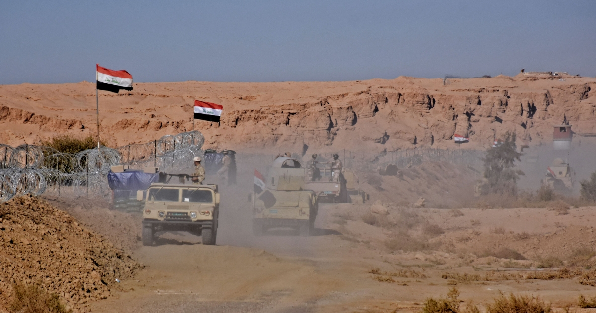 Iraqi forces gather near the al-Qaim border crossing between Syria and Iraq