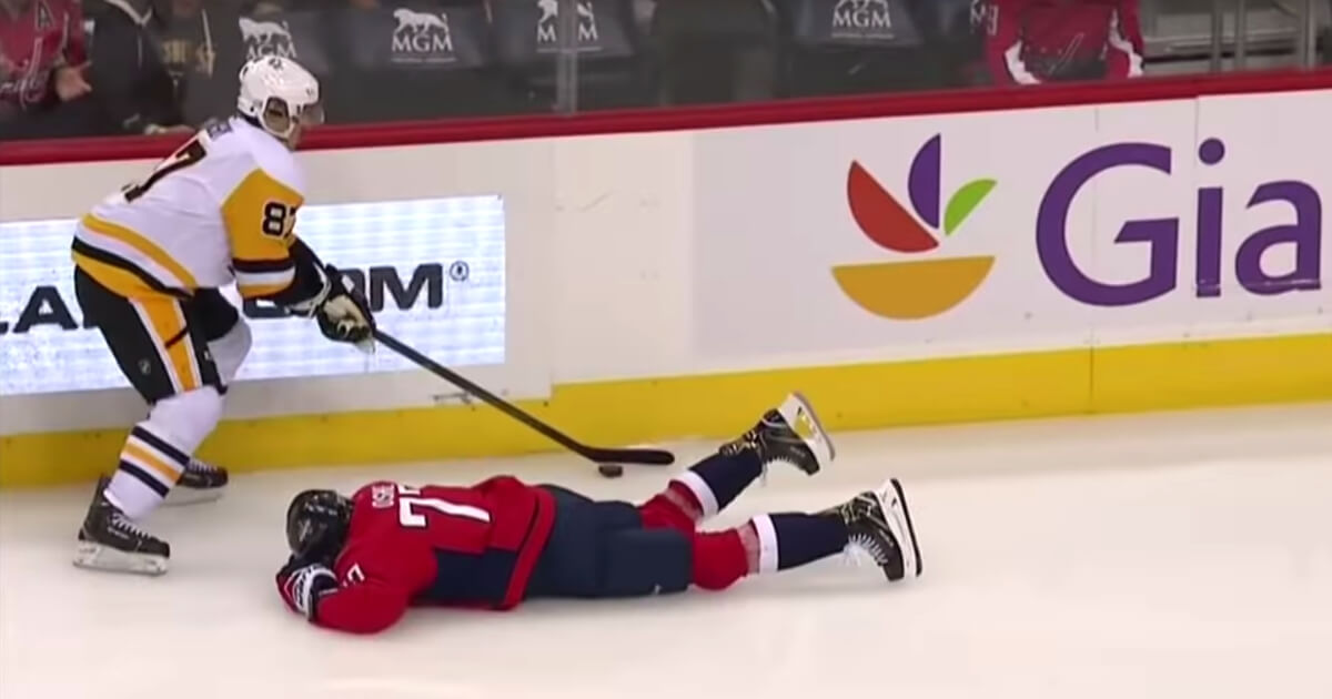 Capitals right winger T.J. Oshie lies on the ice after a brutal hit from Pittsburgh Penguins center Evgeni Malkin on Wednesday.