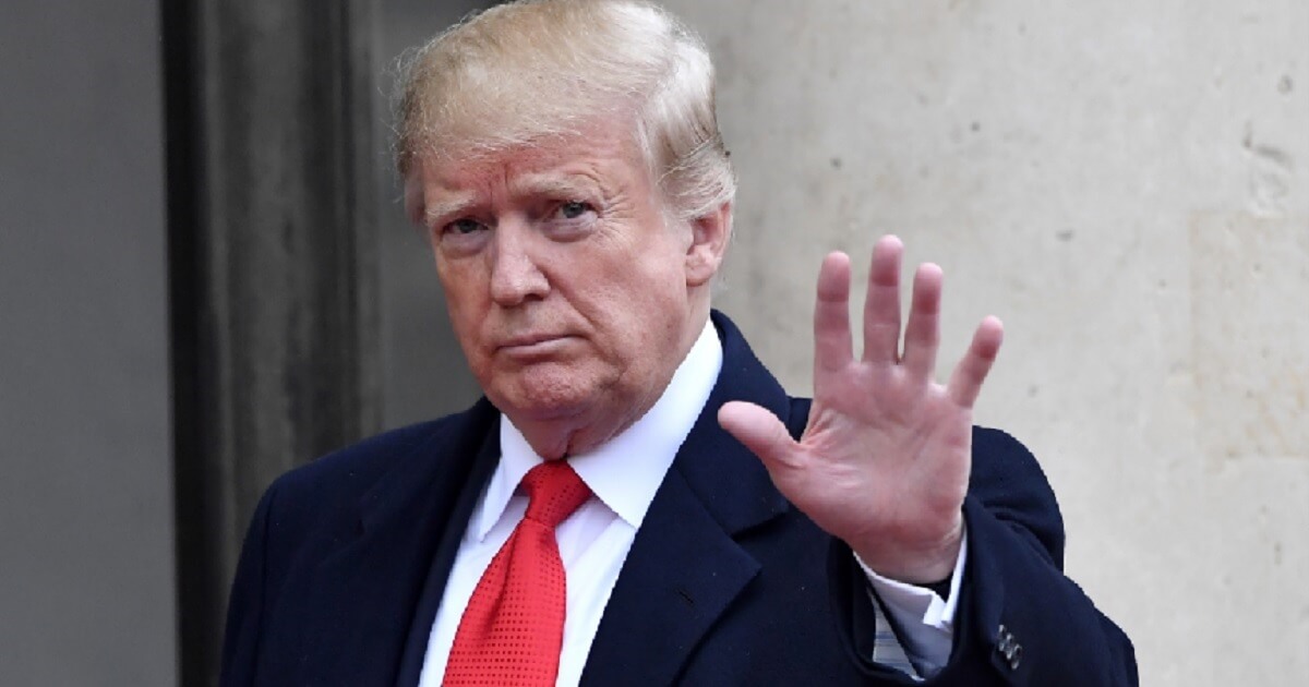 President Donald Trump waves to a camera after arriving for lunch with French President Emmanuel Macron on Saturday in Paris.