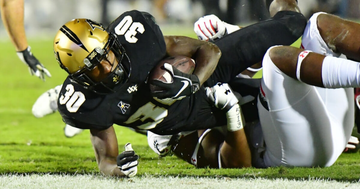 Greg McCrae of the UCF Knights stretches for a touchdown against the Cincinnati Bearcats on Saturday.